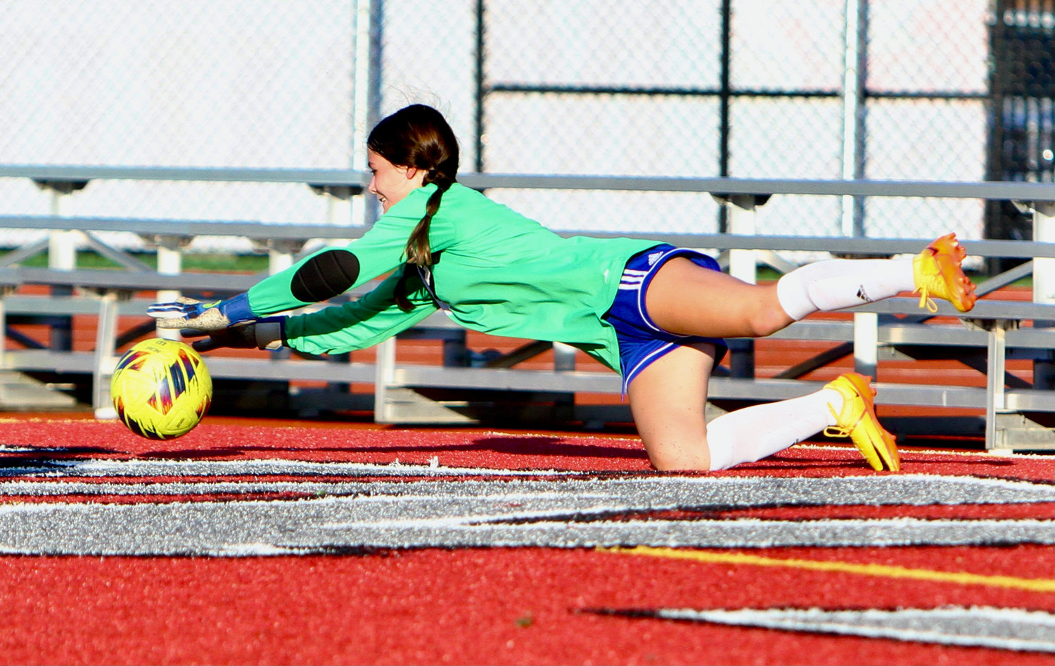 Crawfordsville goalie Zoey Corbin dives to save a shot.